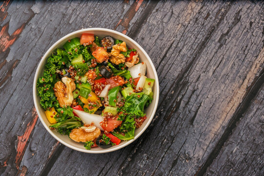 Fresh Quinoa Power salad with isolated wooden background. Breakfast power plate for healthy eating top view. Green healthy salad power plate eating. Vagan power bowl salad.