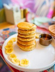 Stack of banana pancakes with maple syrup breakfast