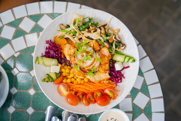 Grilled chicken and squid salad bowl with fresh vegetables