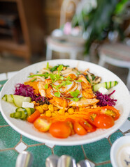 Healthy grilled chicken and squid salad with fresh vegetables