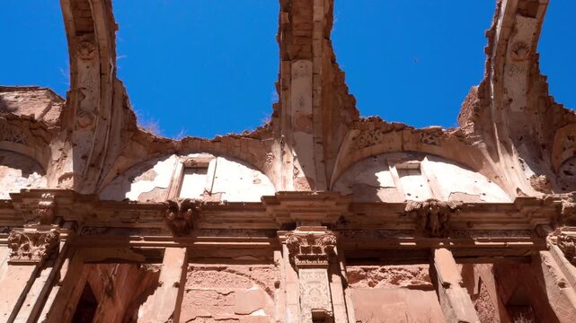 Detailed view of the arched skeletons of the Convent of San Agustin in Belchite, Spain. The eroded stone structures reveal the scars of the Spanish Civil War, capturing texture, history, and silent