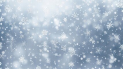 Fototapeta premium Blurred image of falling snowflakes against a soft, light blue background, creating a winter scene