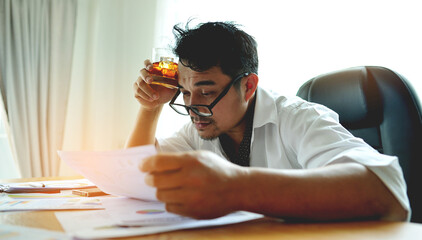 Alcohol consumption in the workplace, emotional state, work-related problems and accumulated stress, anxiety and suicidal thinking. Businessman at a desk with documents.