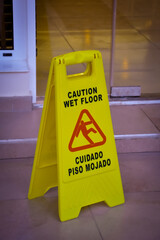 Caution wet floor sign in English and Spanish language