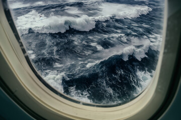 AI. View through airplane window to the ocean storm