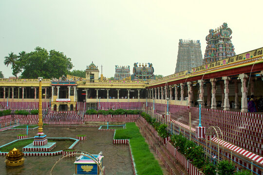 Beautiful view of Madurai Meenakshi Amman temple with tower and golden lotus pond. Interior view of the Meenakshi Amman temple