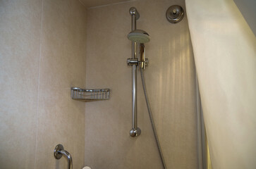 Classic design bathroom with marble sink, shower, towels and mirror and mosaic tiles in cabin or stateroom suite on luxury cruise ship cruiseship liner