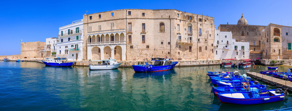 Monopoli. Puglia. Italy. Panorama of the old port with colorful fishinng boats.