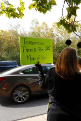 Protestor with bright green sign for No Kings rally