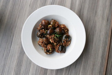 Fresh figs with rosemary served in a white bowl
