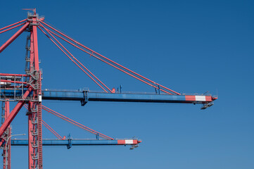 The International Limassol New Port, Large industrial container crane against clear blue sky 