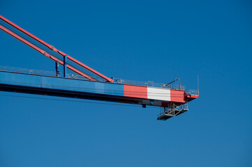 The International Limassol New Port, Large industrial container crane against clear blue sky 