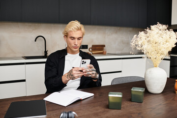 Young man immersed in creativity while relaxing in a modern apartment workspace