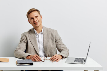 young man working laptop business casual shirt blazer smart office table digital nomad concept...