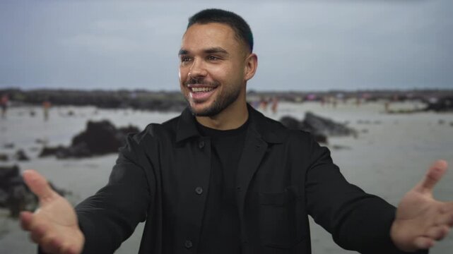 Smiling man with bare arms outstretched in a welcoming open gesture on street; warmth hospitality connection.