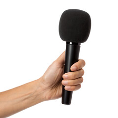 A hand holds a microphone with a fuzzy windscreen against a black background, emphasizing the equipment for audio recording or broadcasting.