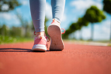Woman walking on running track for fitness exercise