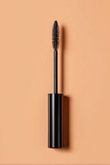 Black cosmetic applicator wand extends from a sleek cylindrical handle against a plain warm background