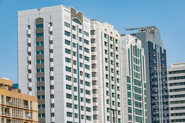 New modern high-rise residential buildings under blue sky in city. Modern apartments with balconies