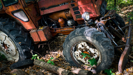 Close-up of weathered red tractor headlight