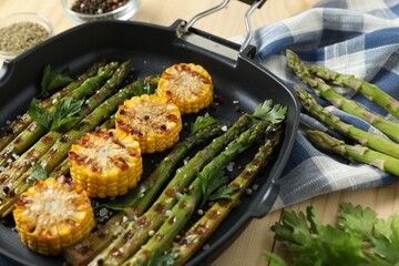 Delicious grilled vegetables with spices in pan on table, closeup