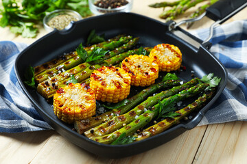 Delicious grilled vegetables with spices in pan on wooden table, closeup