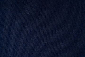 Navy blue merino wool sweater texture as background. Top view.