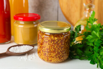 Different tasty sauces, parsley and salt on white wooden table, closeup