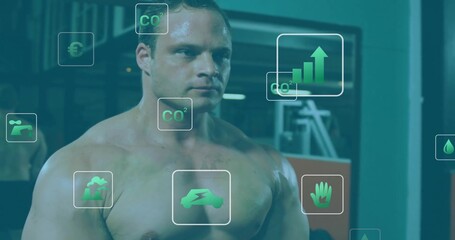 Standing shirtless man projecting green CO2, electric vehicle and bar chart icons in fitness center
