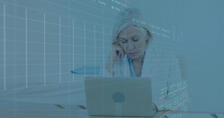 Leaning senior woman wearing blazer analyzing data on laptop in office, with notebook and overlay