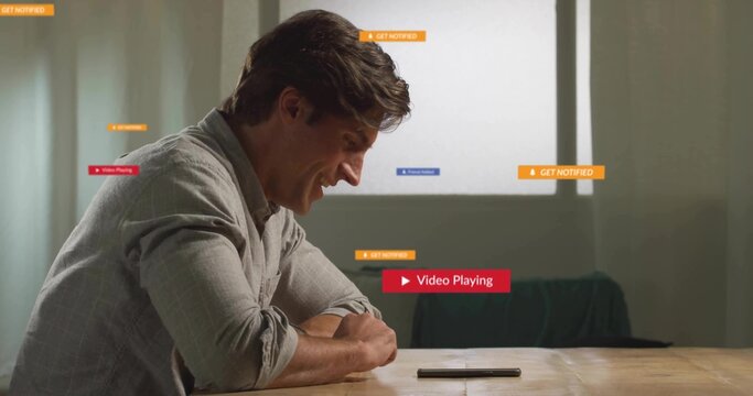 Leaning man wearing shirt smiling at smartphone on wooden table in living area with notifications - Powered by Adobe
