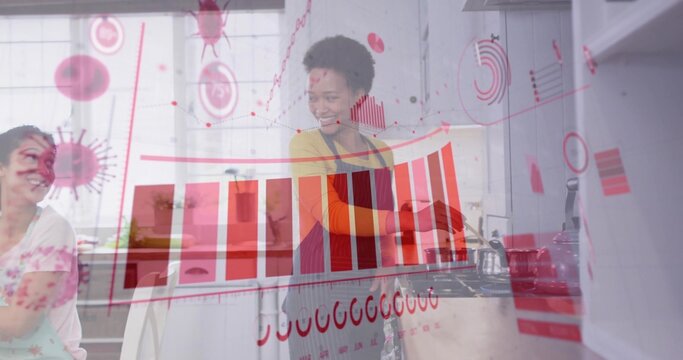 Washing dishes African American woman wearing apron at sink in kitchen, with red data overlay