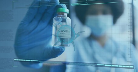 Masked nurse wearing blue scrubs and gloves holding COVID-19 Injection vial in lab with overlays