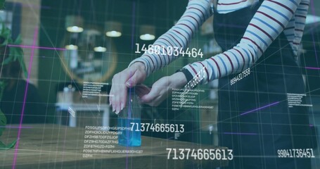 Adjusting woman in overalls manipulating holographic grid and data at cafe table with blue cube