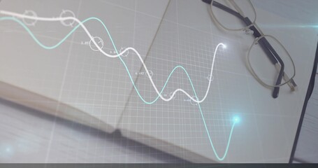 Presenting spiral-bound notebook featuring grid overlay on wooden desk, with metal-frame eyeglasses