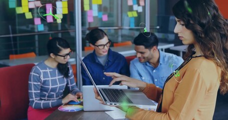 Collaborating woman in orange blouse leading color wheel discussion in meeting room, copy space