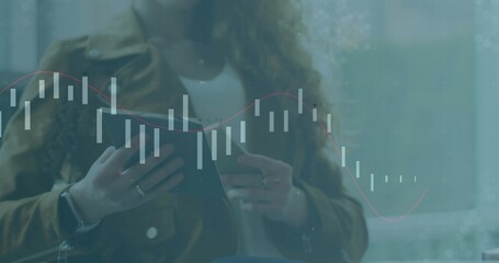 Analyzing woman holding tablet and viewing financial data overlay by window, with smartwatch, rings