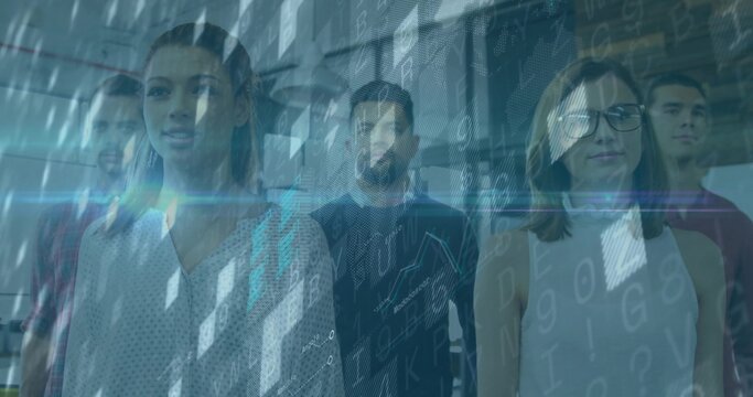 Standing group of software professionals examining digital code overlay in glass-partition office