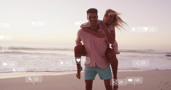 Standing man carrying woman at waterline on beach sunset in light clothes, with social media icons