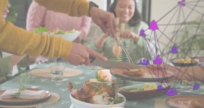 Host positioning tools and carving turkey while assistant tossing salad during dinner service