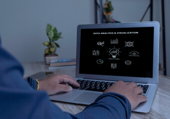 Businessman at laptop with a data analysis and visualization flowchart. Concept of using ideas,...