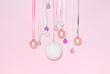 Christmas ornaments on a pastel pink background. Place fot text