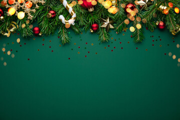 Christmas background with xmas tree, christmas decoration and sparkle bokeh lights on green background. Merry Christmas greeting card. Winter holiday theme. Happy New Year. Space for text	

