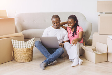 African couple moving to new home planning online