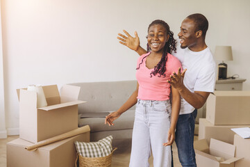 Happy African couple celebrating new apartment moving day