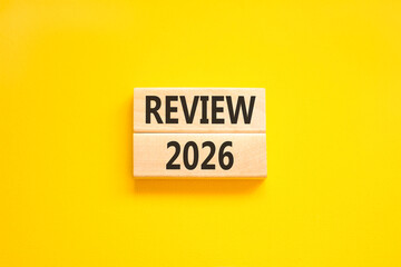 Review 2026 symbol. Concept words Review 2026 on beautiful wooden blocks. Beautiful yellow paper background. Business and review 2026 concept. Copy space.