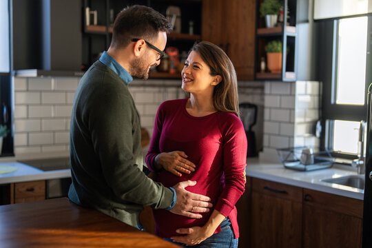 Man in love hugs his pregnant wife, they are waiting together for the baby's arrival. Love, family