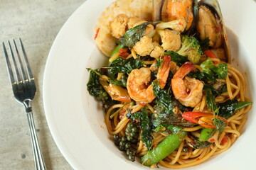 Delicious Seafood Spaghetti dish on white plate with a fork