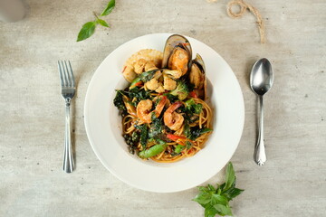 Delicious Seafood Pasta Served On a Plate, With Fork And Spoon 