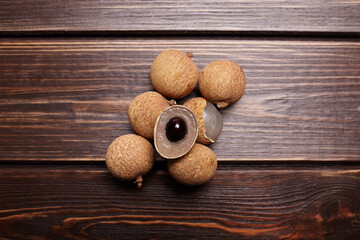 Longan tropical fruit displayed on a rustic wooden surface, showcasing its unique texture and color, emphasizing freshness and natural beauty in a vibrant setting